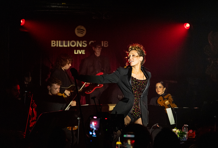 Miley Cyrus on stage with her band behind her